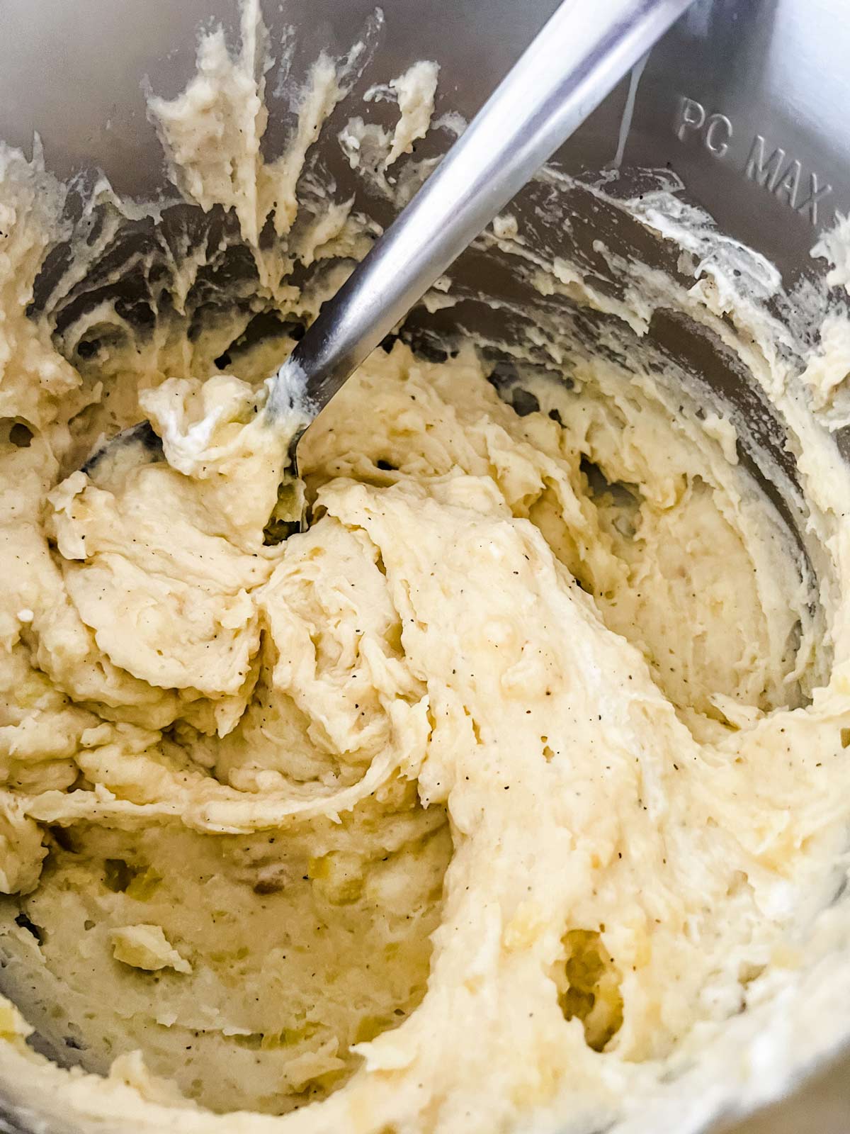 A final stir for Instant Pot garlic mashed potatoes.