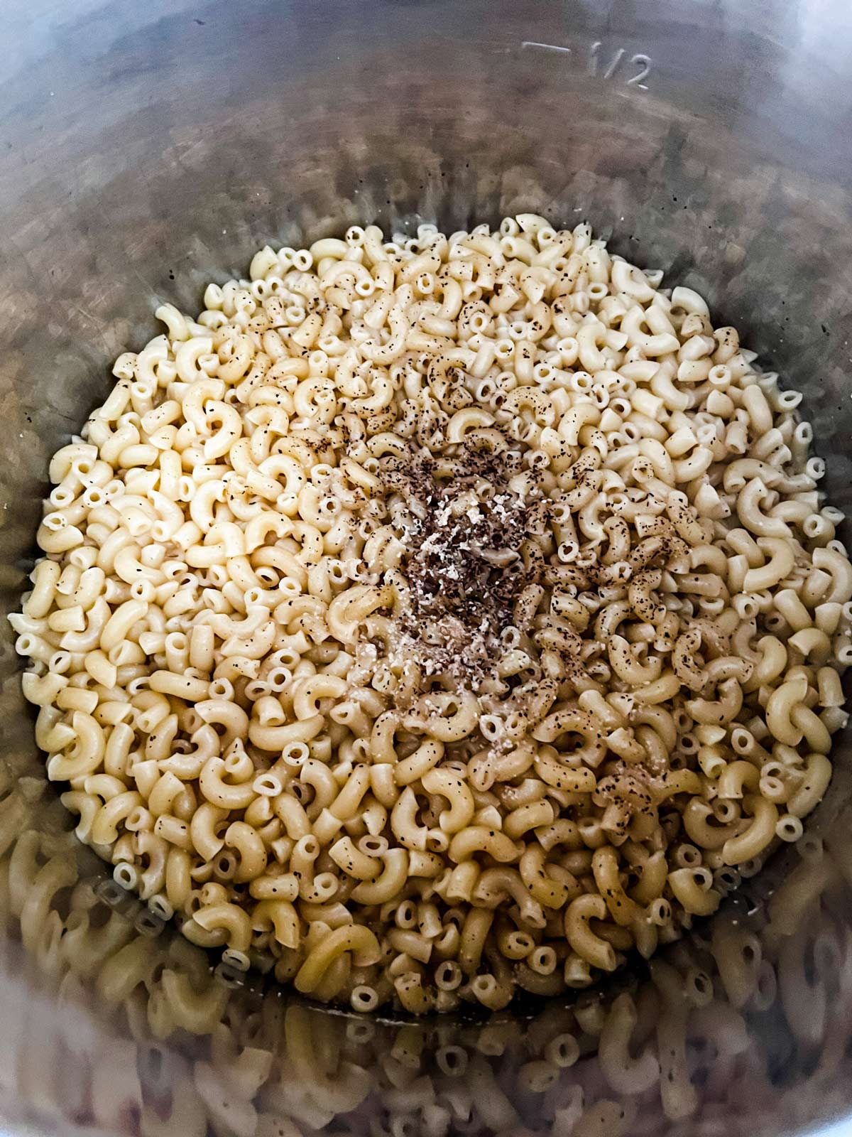 Elbow noodles and seasonings that have been cooked in an Instant Pot.