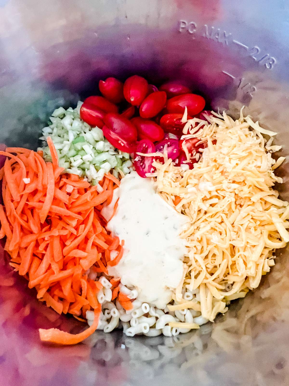 Instant Pot macaroni salad ingredients in the inner pot of an Instant Pot ready to be tossed together.