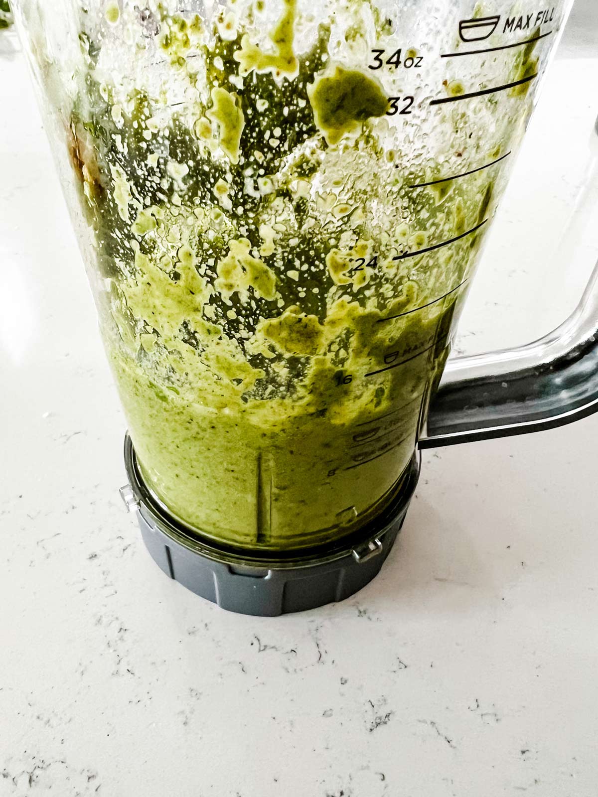 Side photo of pesto without pine nuts in a blender.