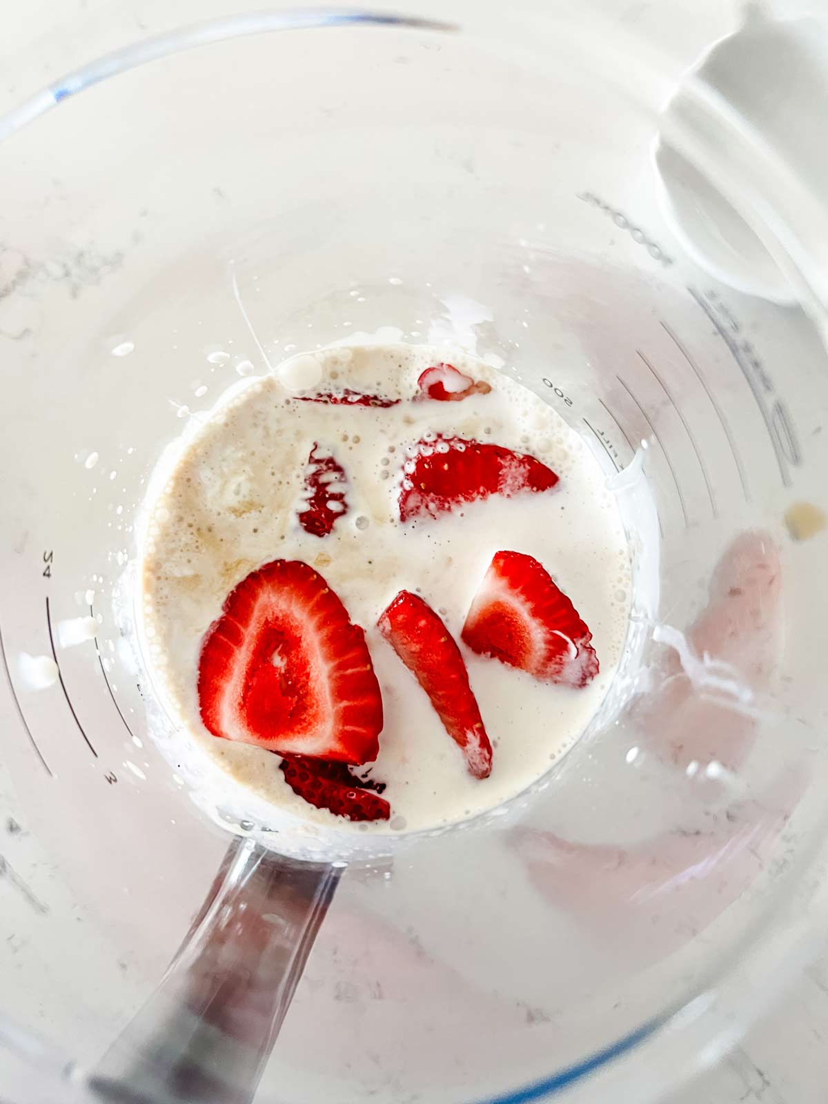 The base for strawberry ice cream in a blender ready to blend.