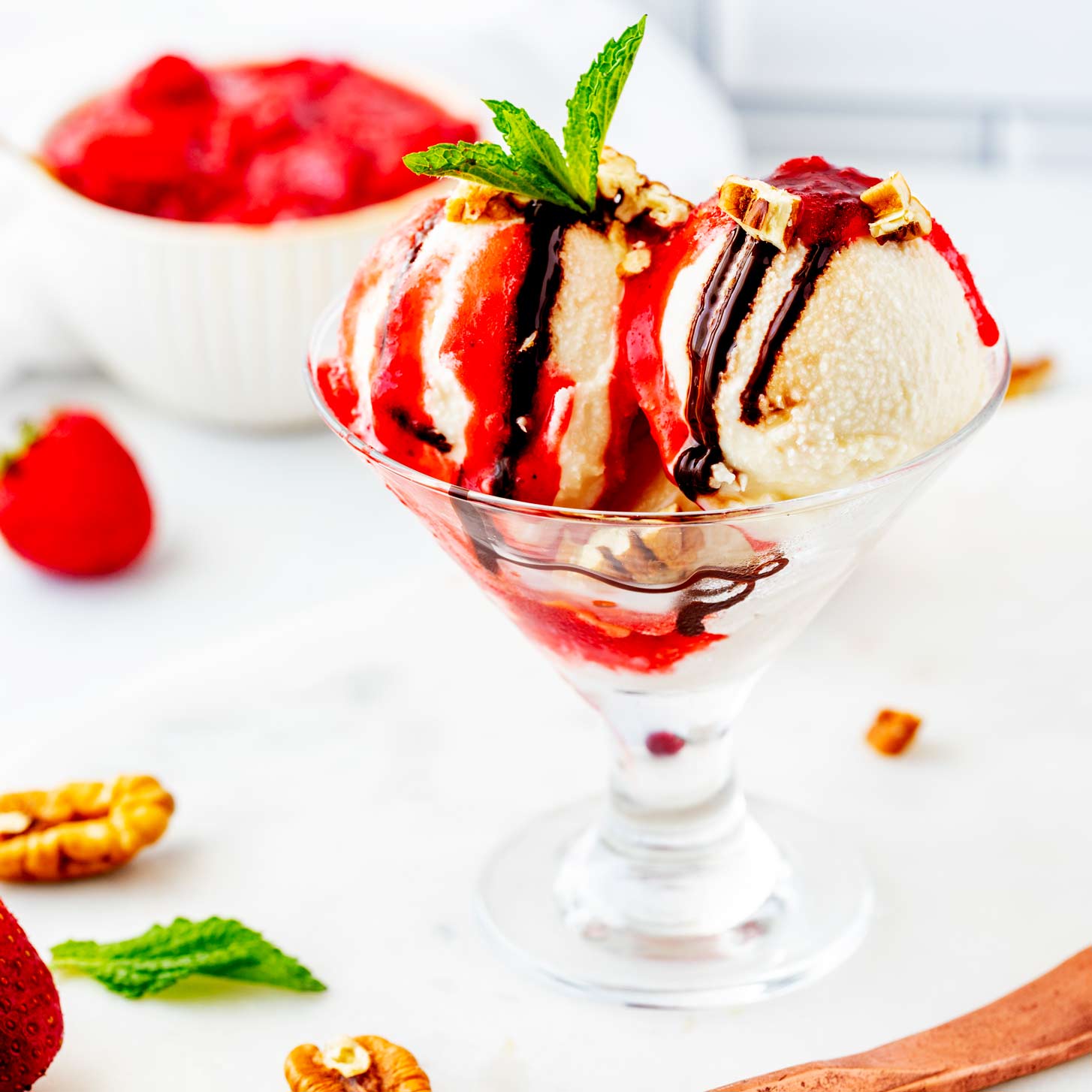 Side photo of Ninja Creami vanilla ice cream drizzled with strawberry sauce and chocolate sauce.