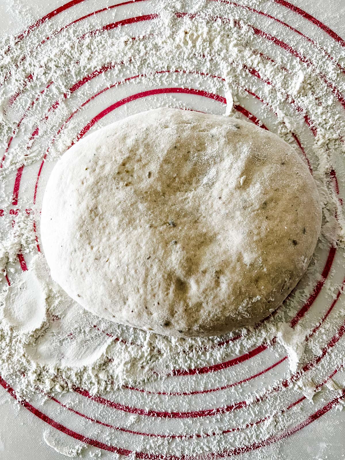 Bread dough on a flour dusted pastry mat.