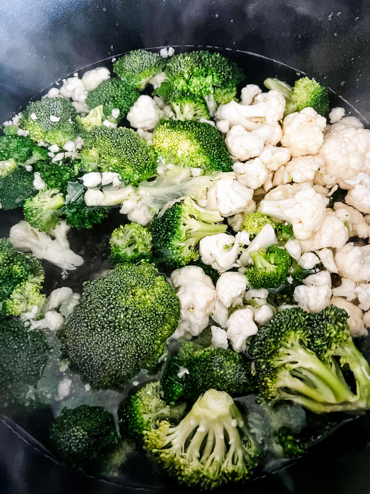 Broccoli and cauliflower in a pot of water blanching.