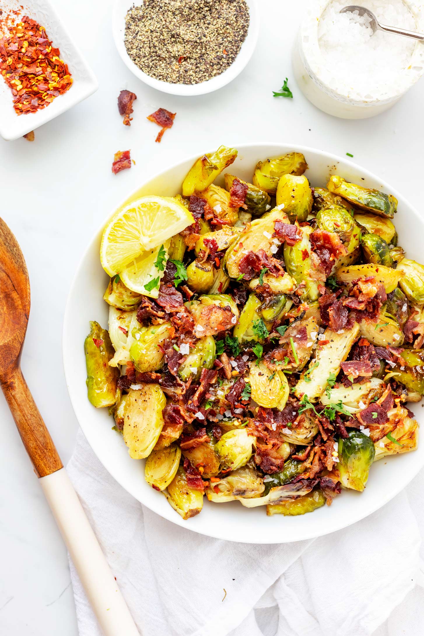Photo of Brussels Sprouts with Bacon in a shallow white plate.