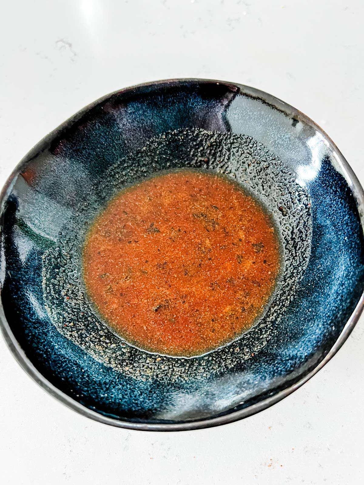 Seasoning mixture in a small blue bowl.