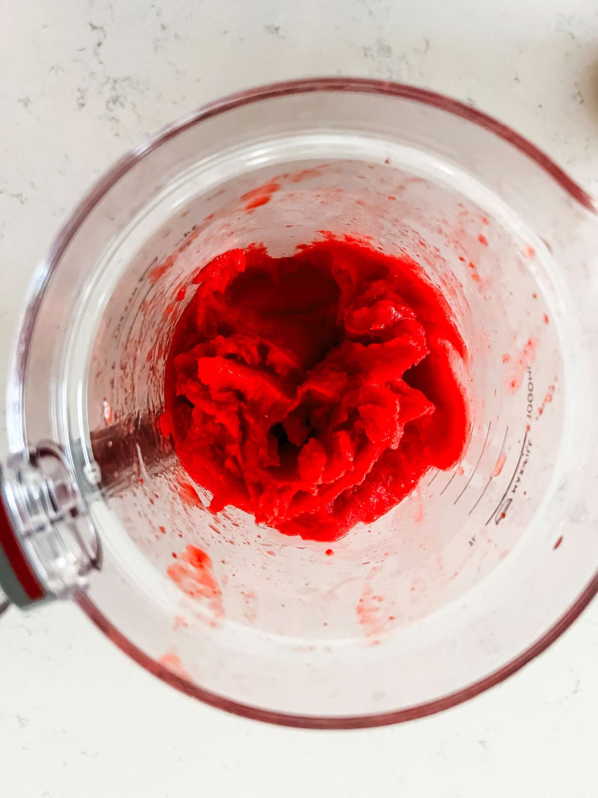 The base for ninja creami strawberry sorbet that has been blended in a blender.