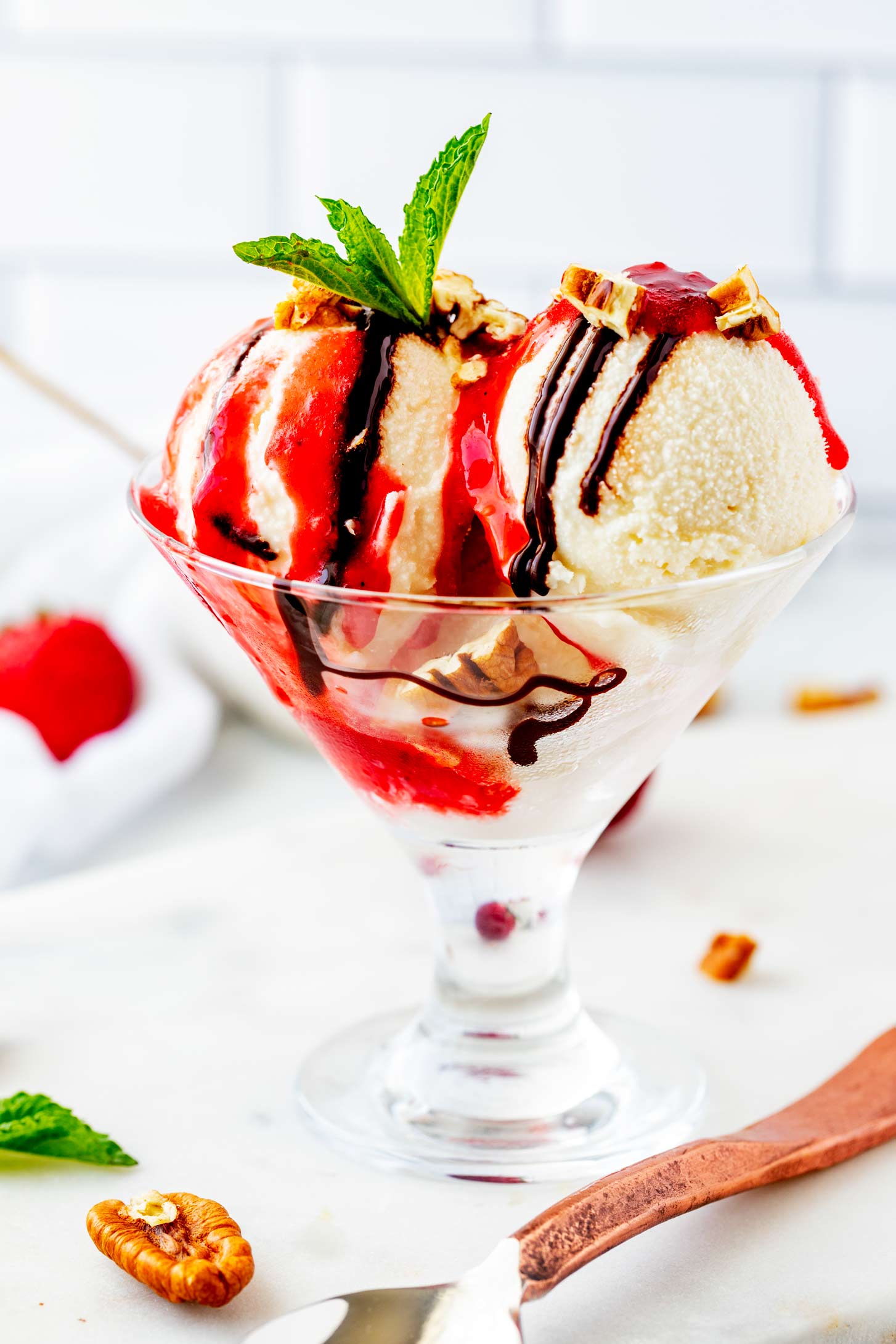 Side photo of Ninja creami vanilla ice cream in a glass ice cream dish.