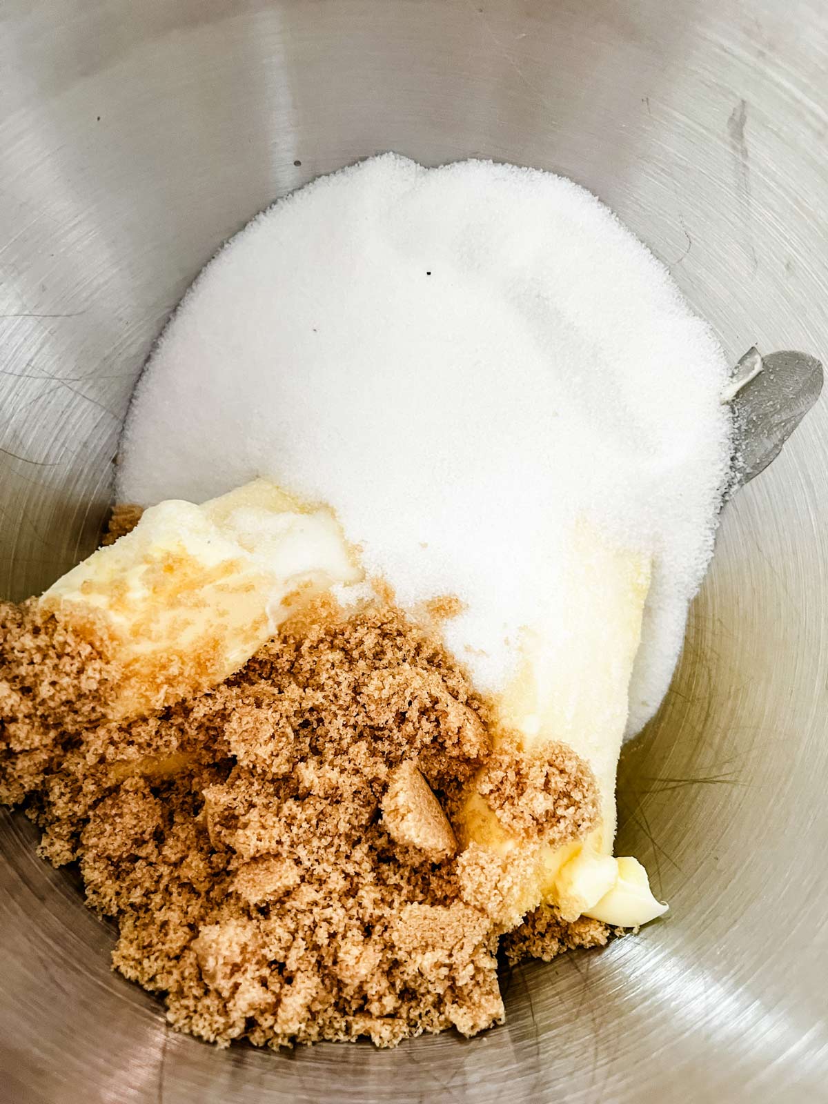 Sugars and butter in the bowl of a stand mixer.