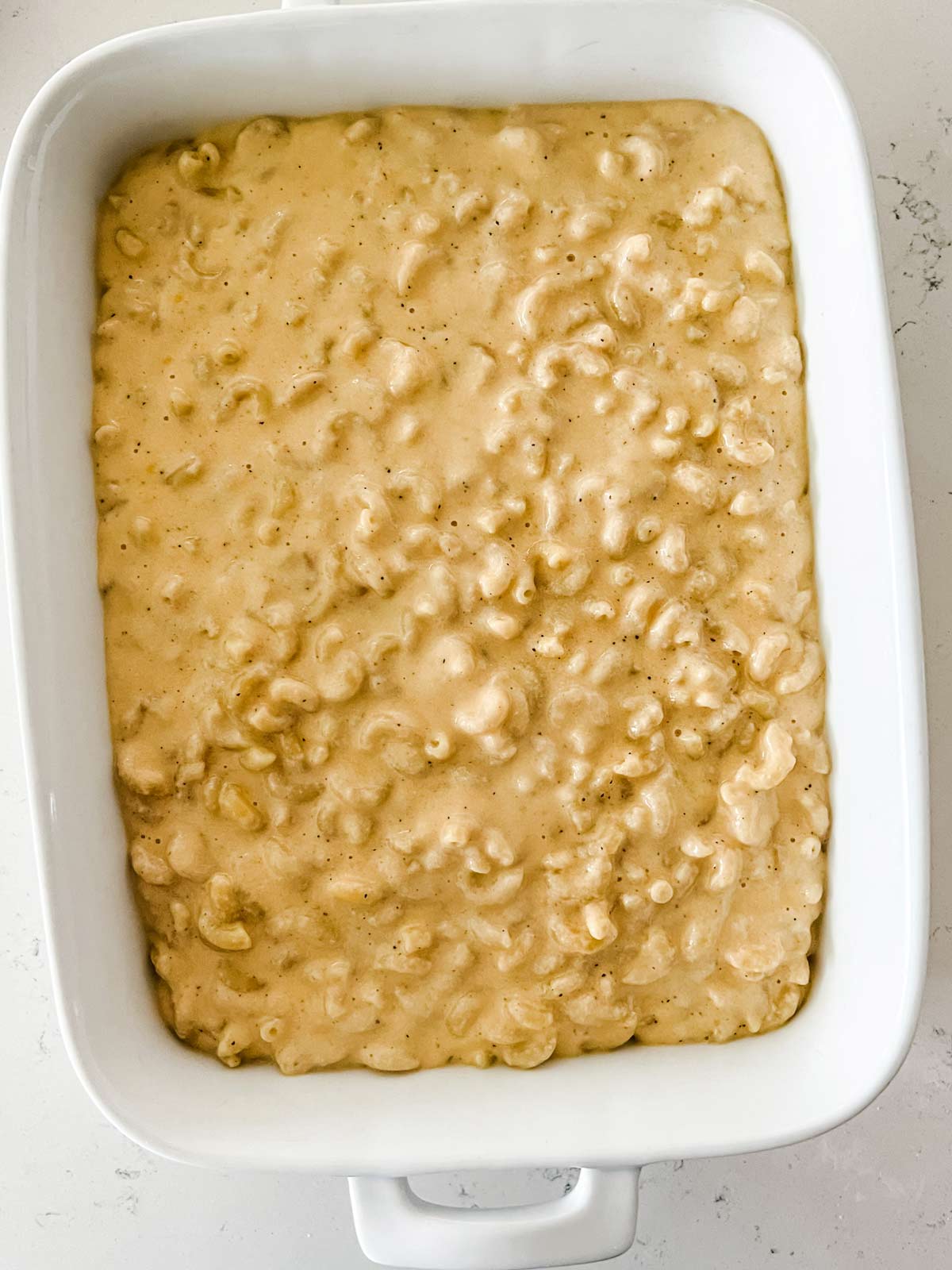 Macaroni and cheese in a white casserole dish.