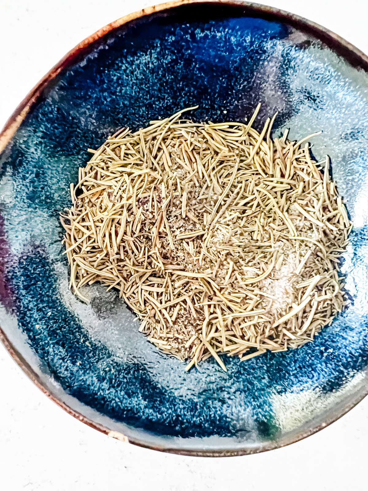 A small blue dish with seasonings.