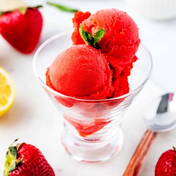 Square side photo of Ninja Creami Strawberry sorbet in a glass dish garnished with mint