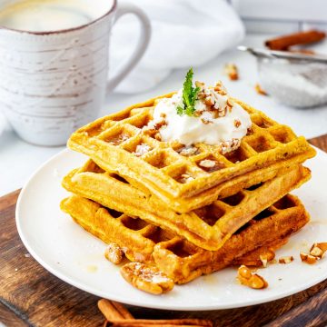 Side square photo of three stacked pumpkin waffles.