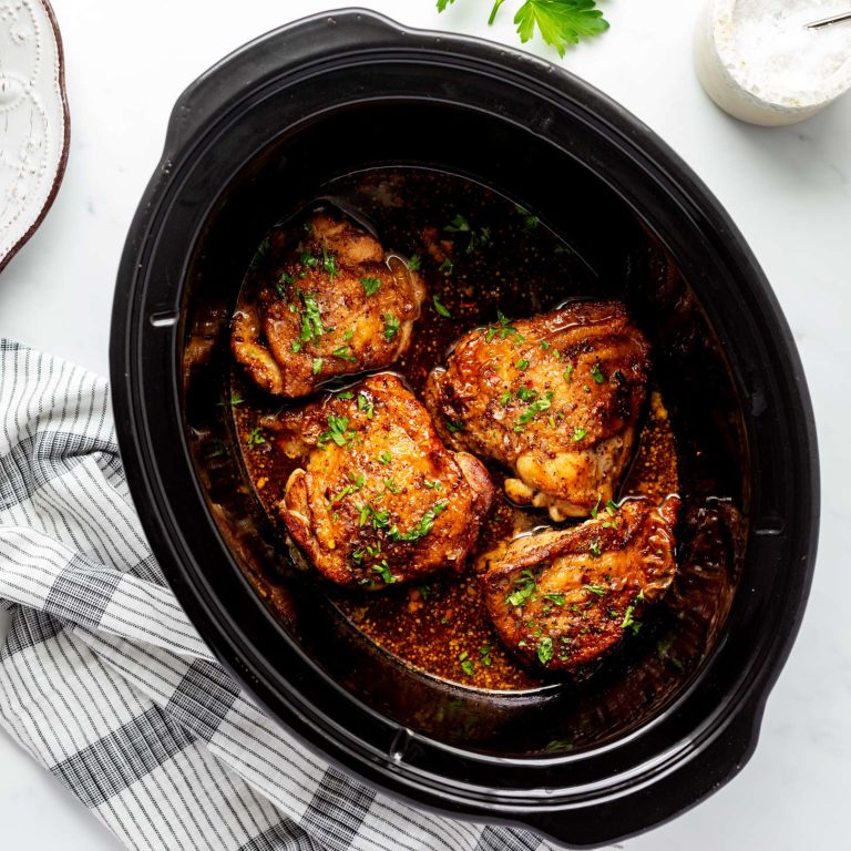 Overhead photo of soy honey garlic chicken thighs in a slow cooker.