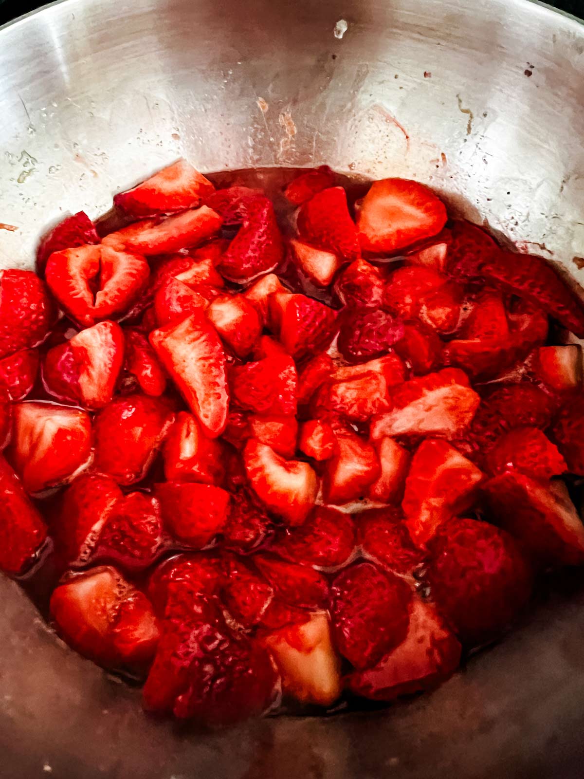 Sliced strawberries in a saucepan to make strawberry compote.