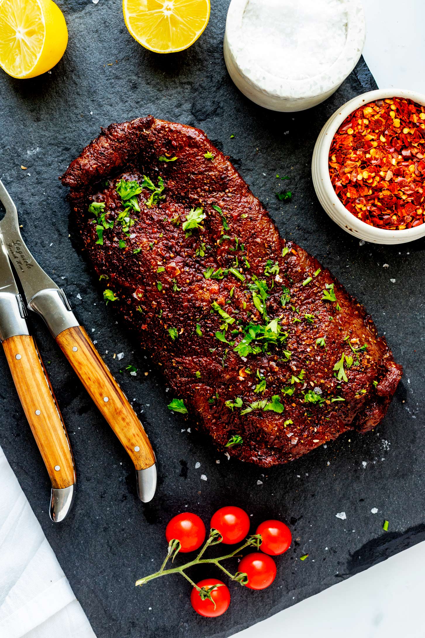 Overhead photo of flat iron steak on a slate platter.