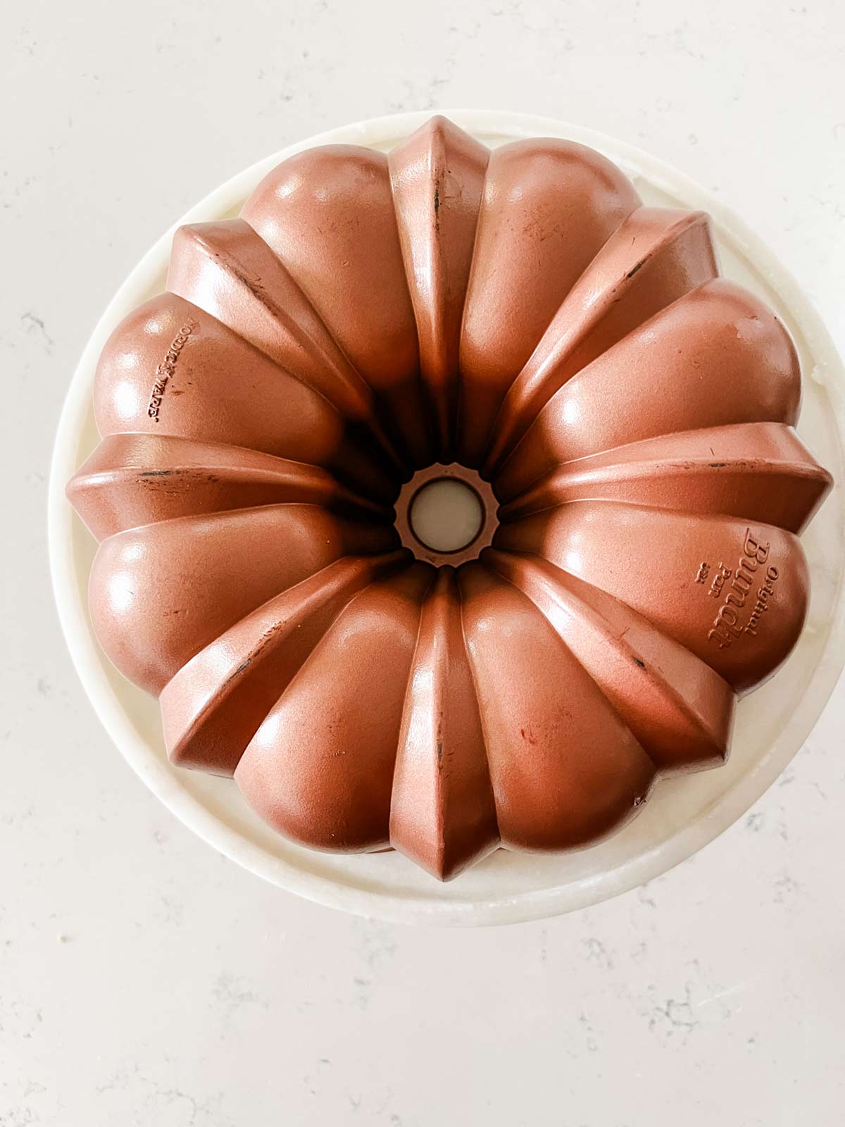 An inverted Bundt pan on a cake stand.