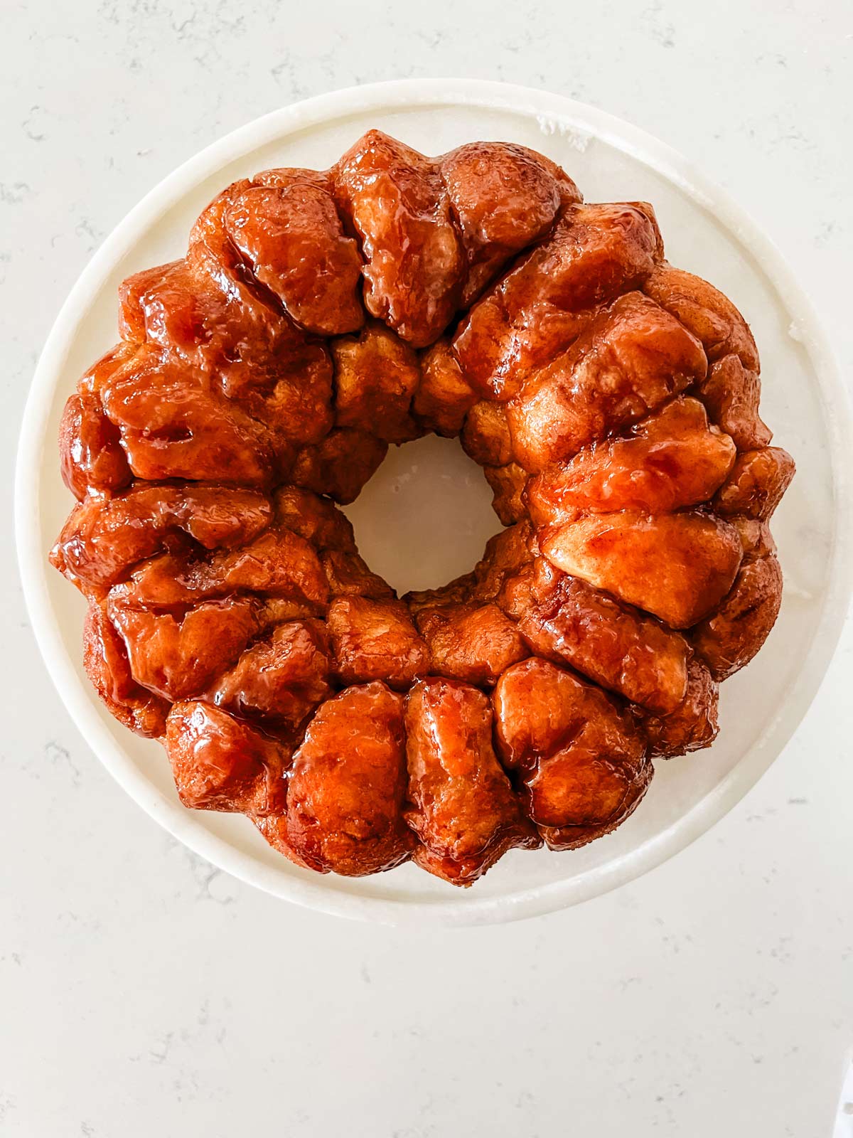Unglazed monkey bread strait from the pan on a cake stand.