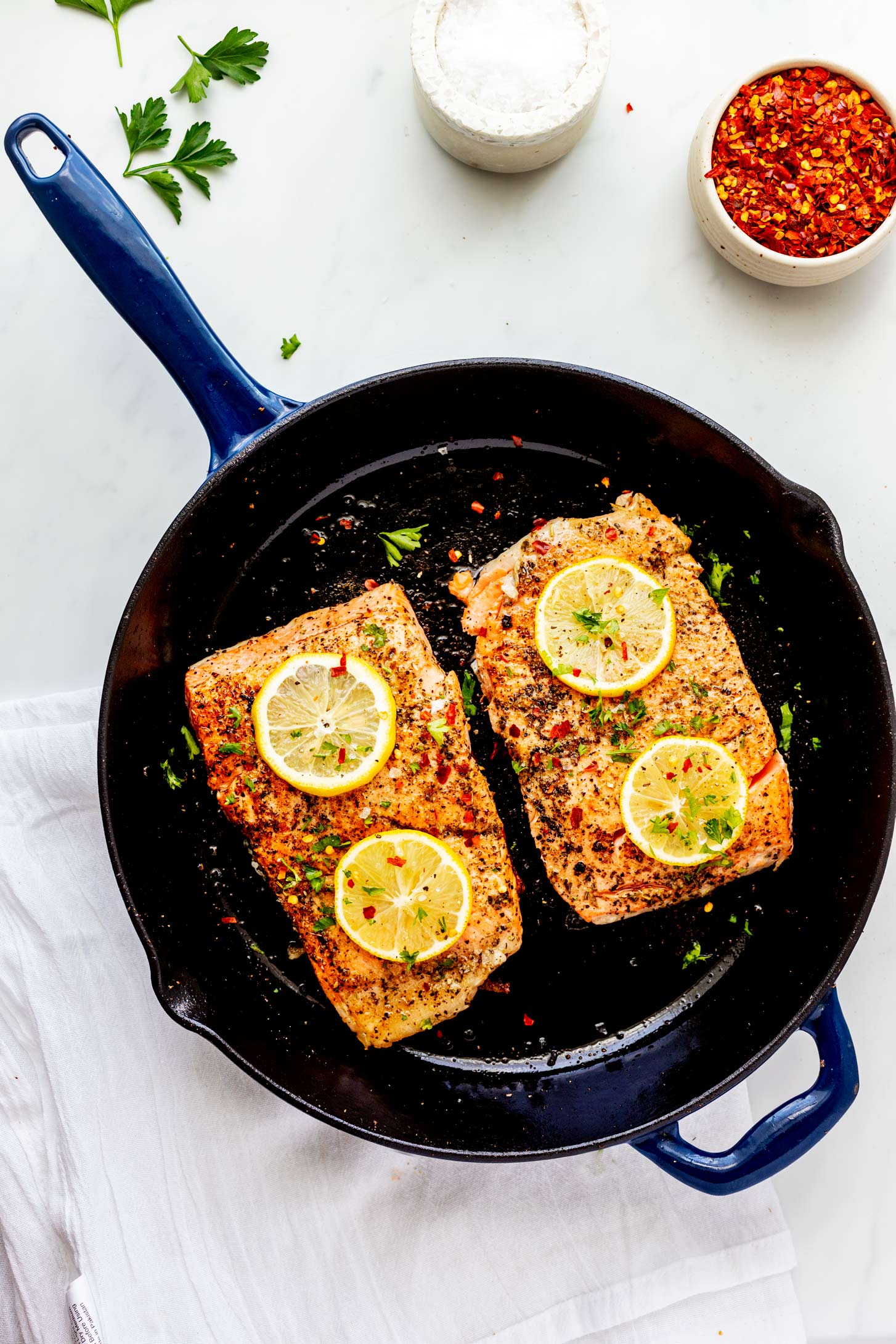 Overhead photo of cooked salmon in a cast iron skillet.