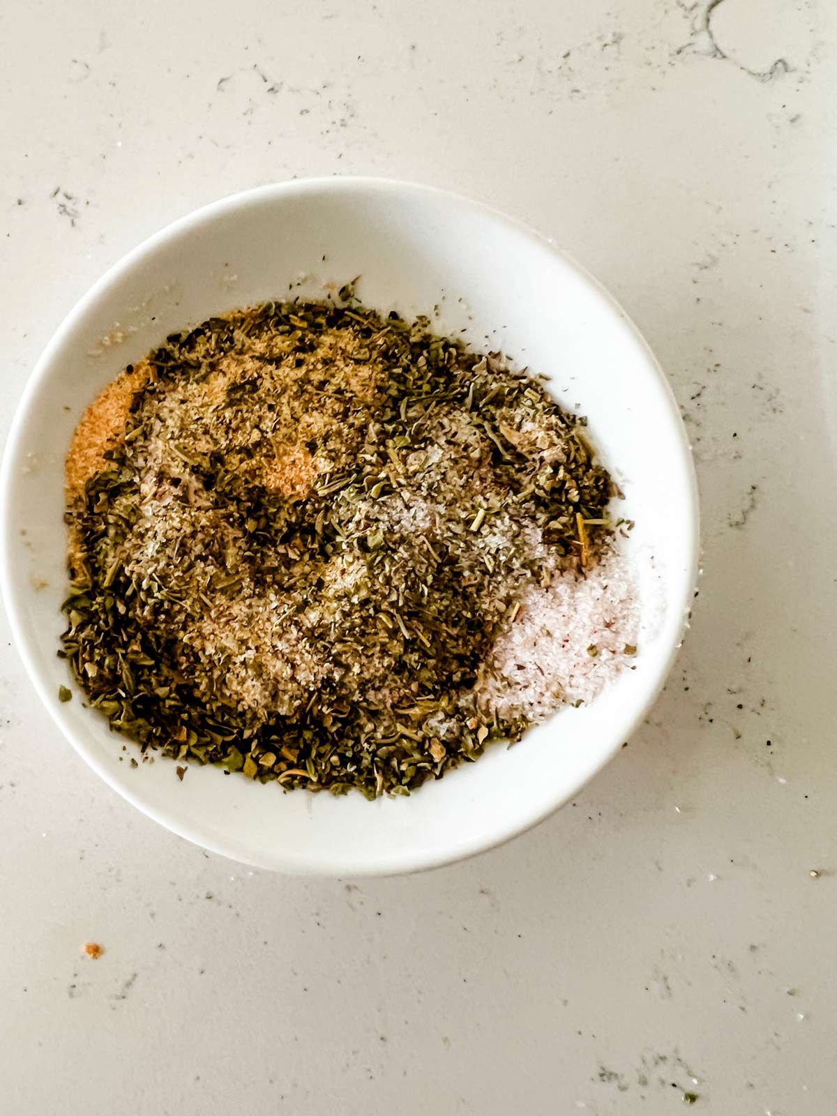 Seasoning mixture in a small white dish.