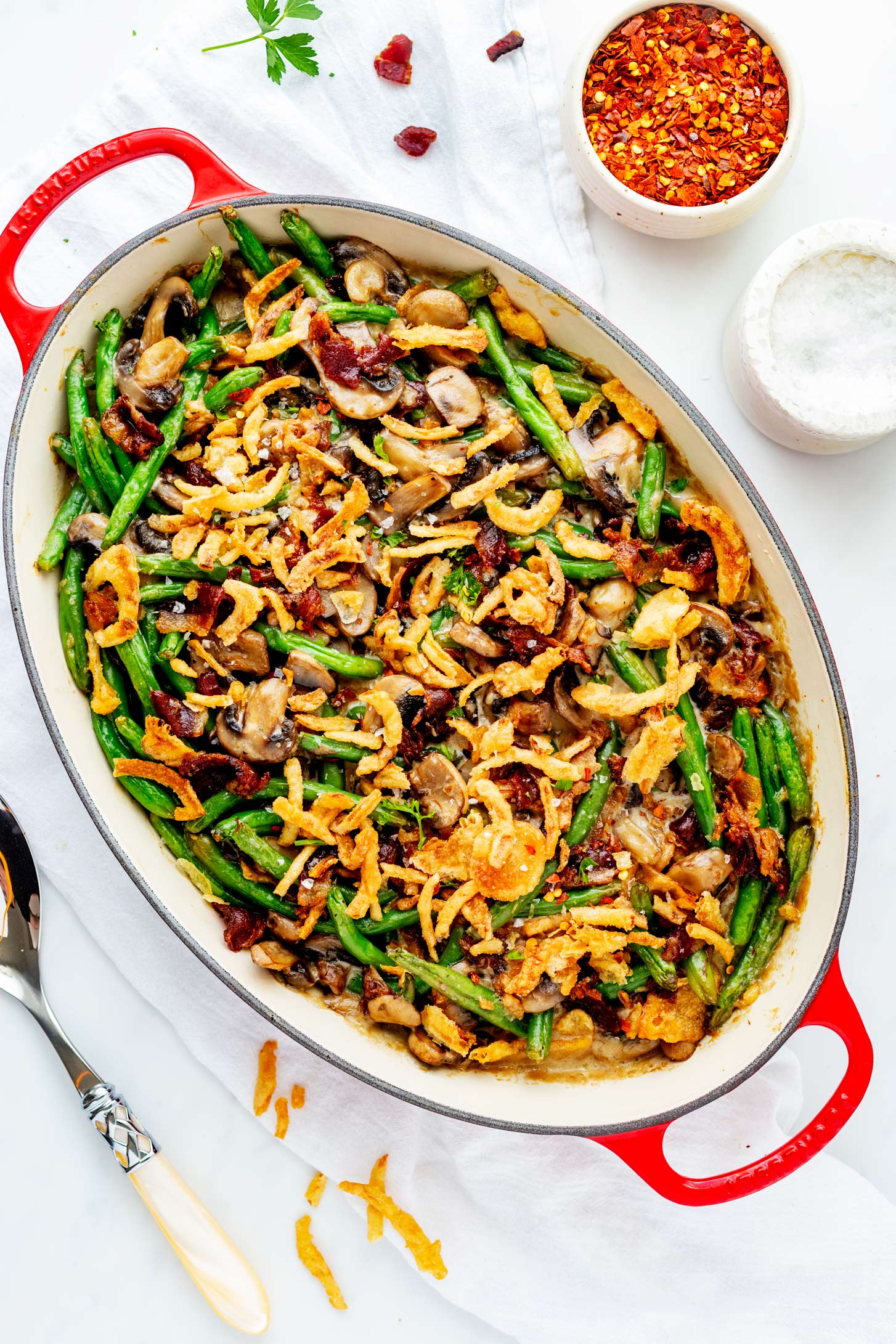 Close up overhead photo of a casserole dish with green bean casserole with bacon in it.