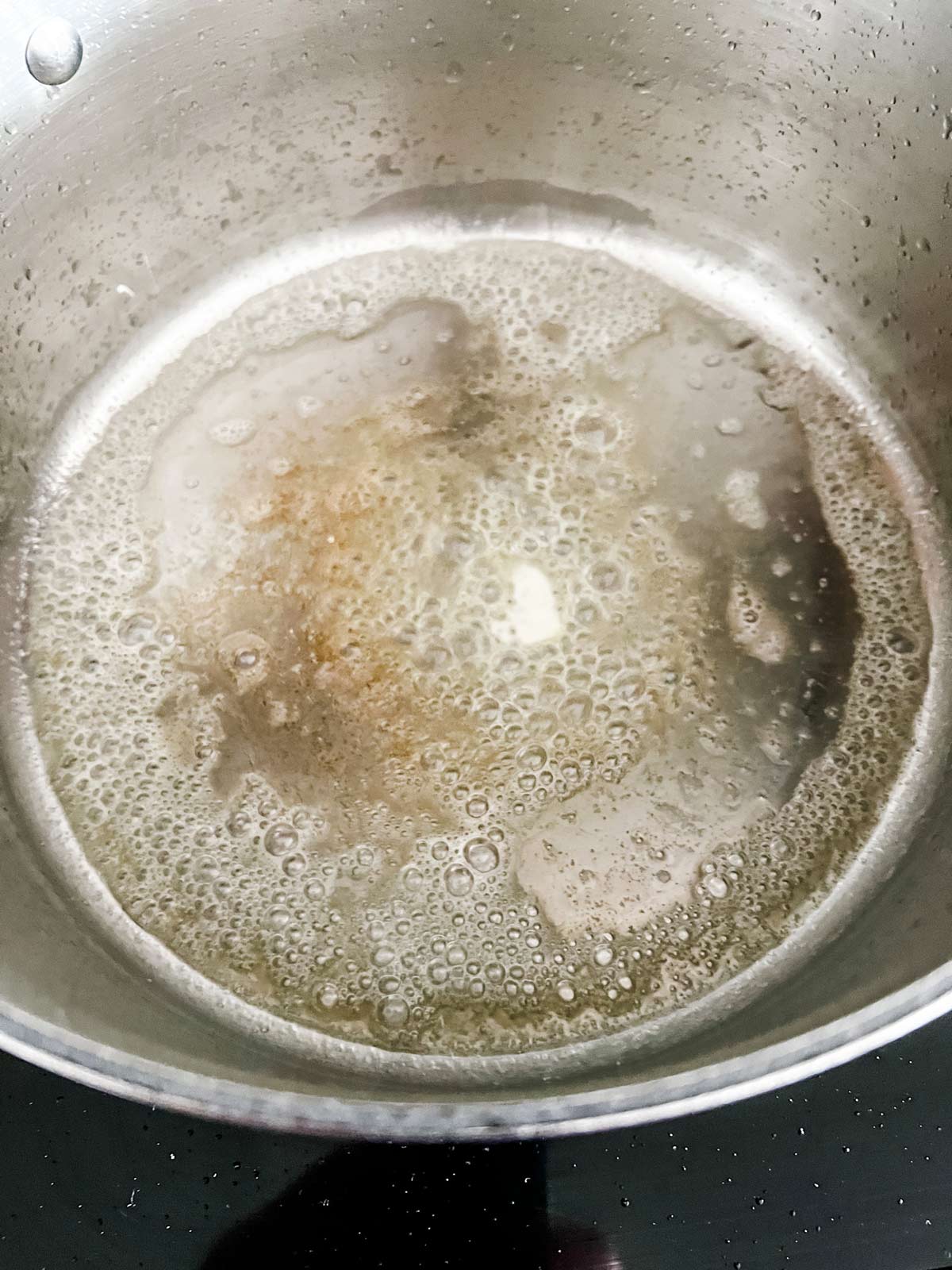 Melted butter in a large pot.
