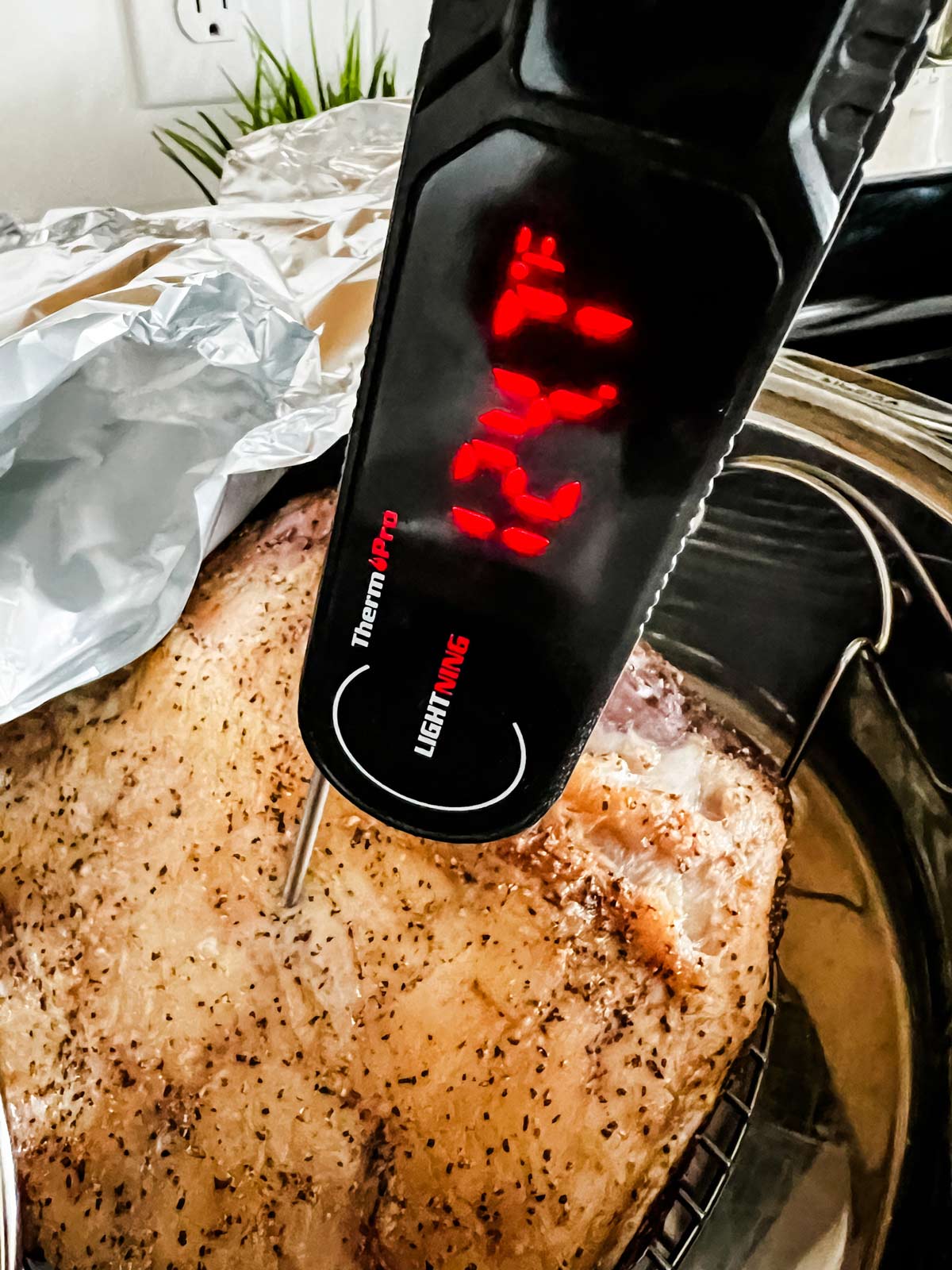 Reverse sear primer ribe that has been slow roasted and has a meat thermometer in it that reads 124.7° F.