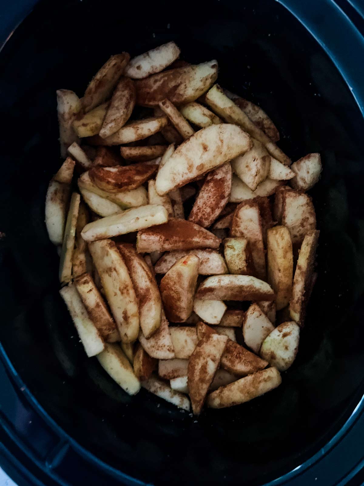 Overhead photo of cinnamon sugar apples in a slow cooker.