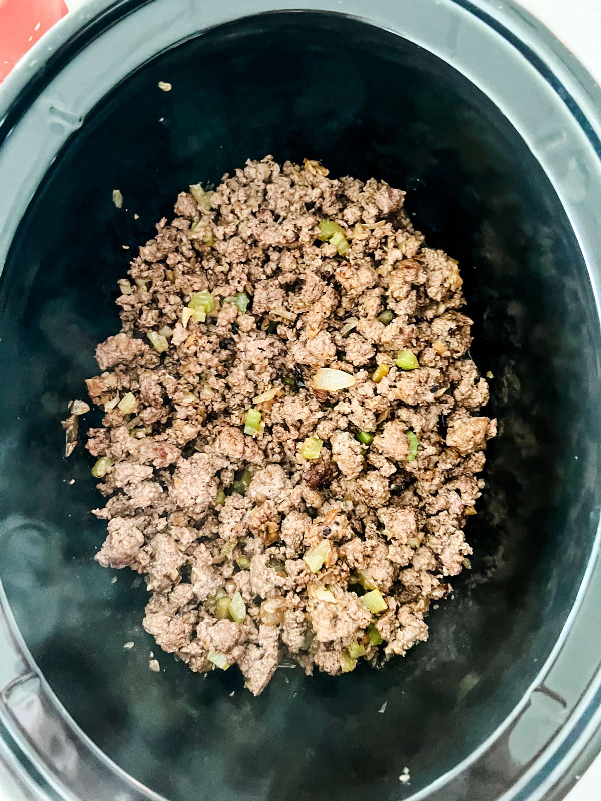 Browned ground beef, onion, and celery in a 