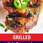 Close up overhead photo of grilled chipotle chicken garnished with jalapeno with the text Grilled Chipotle Chicken recipe below.