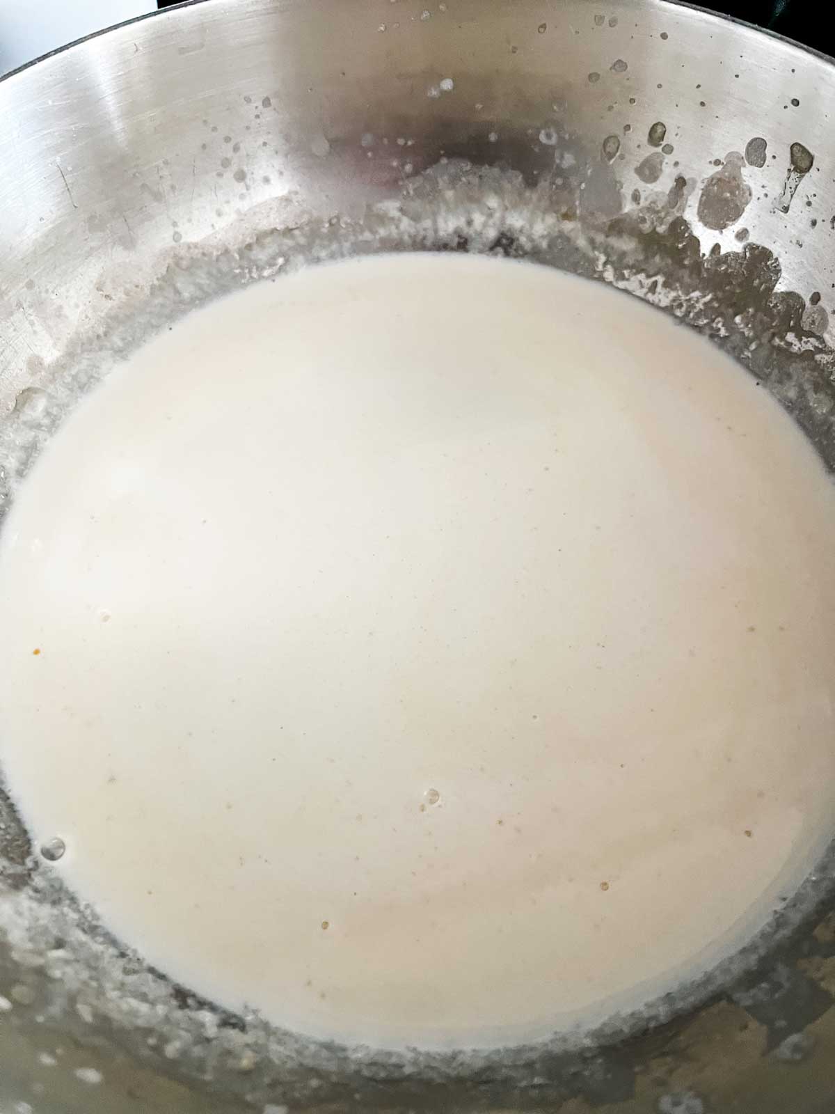 A cream sauce in a saucepan.