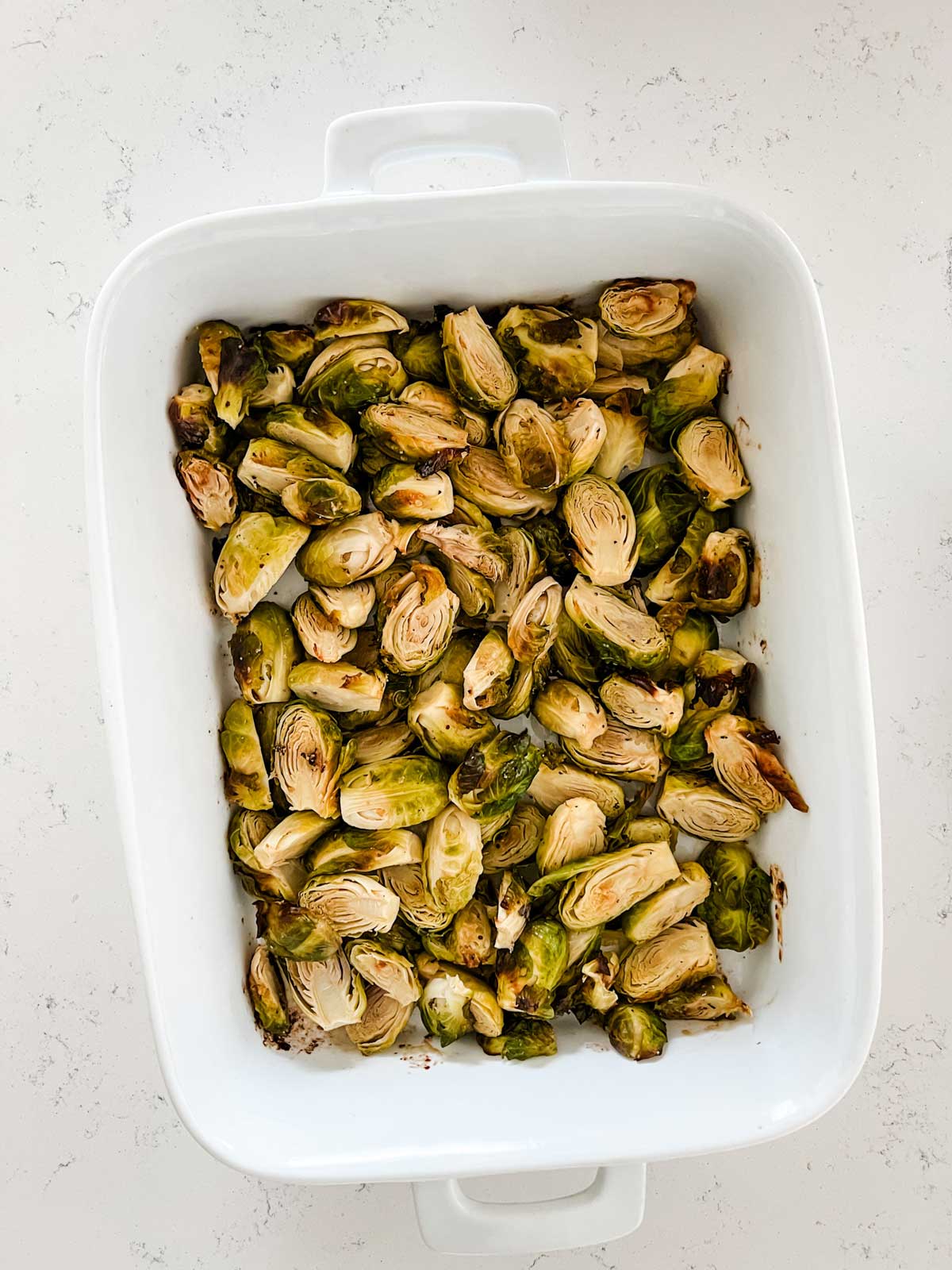 Overhead photo of brussels sprouts in a casserole dish.