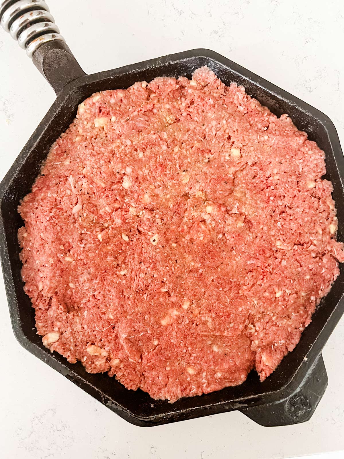 Meatloaf in a cast iron skillet ready for the oven.