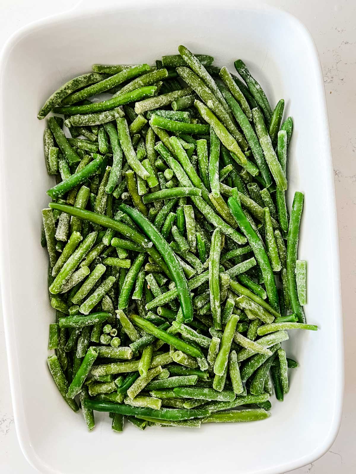 Frozen green beans in a 13 x 9 casserole dish.