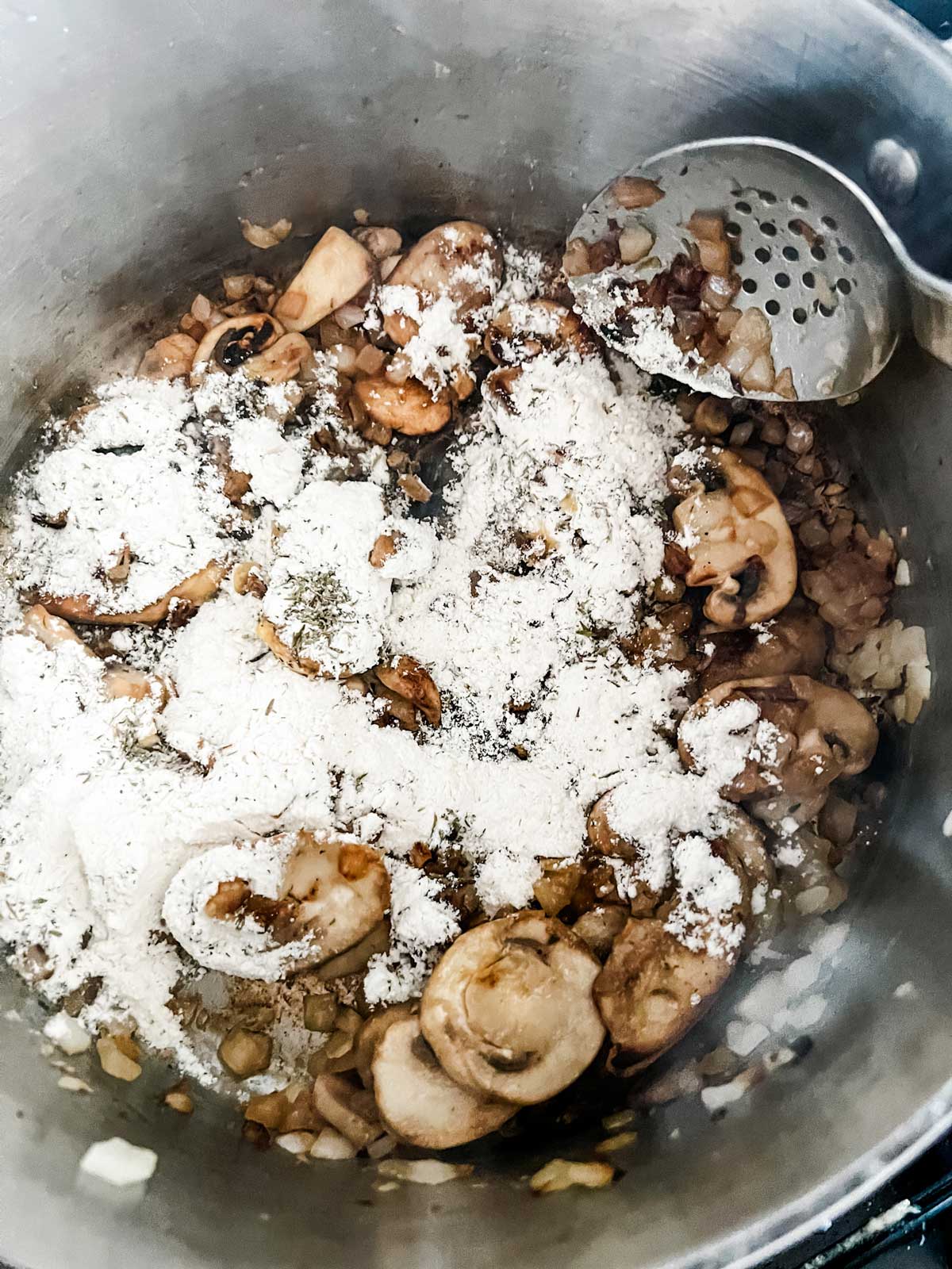 Sautéed mushrooms and onions that have been sprinkled with flour.