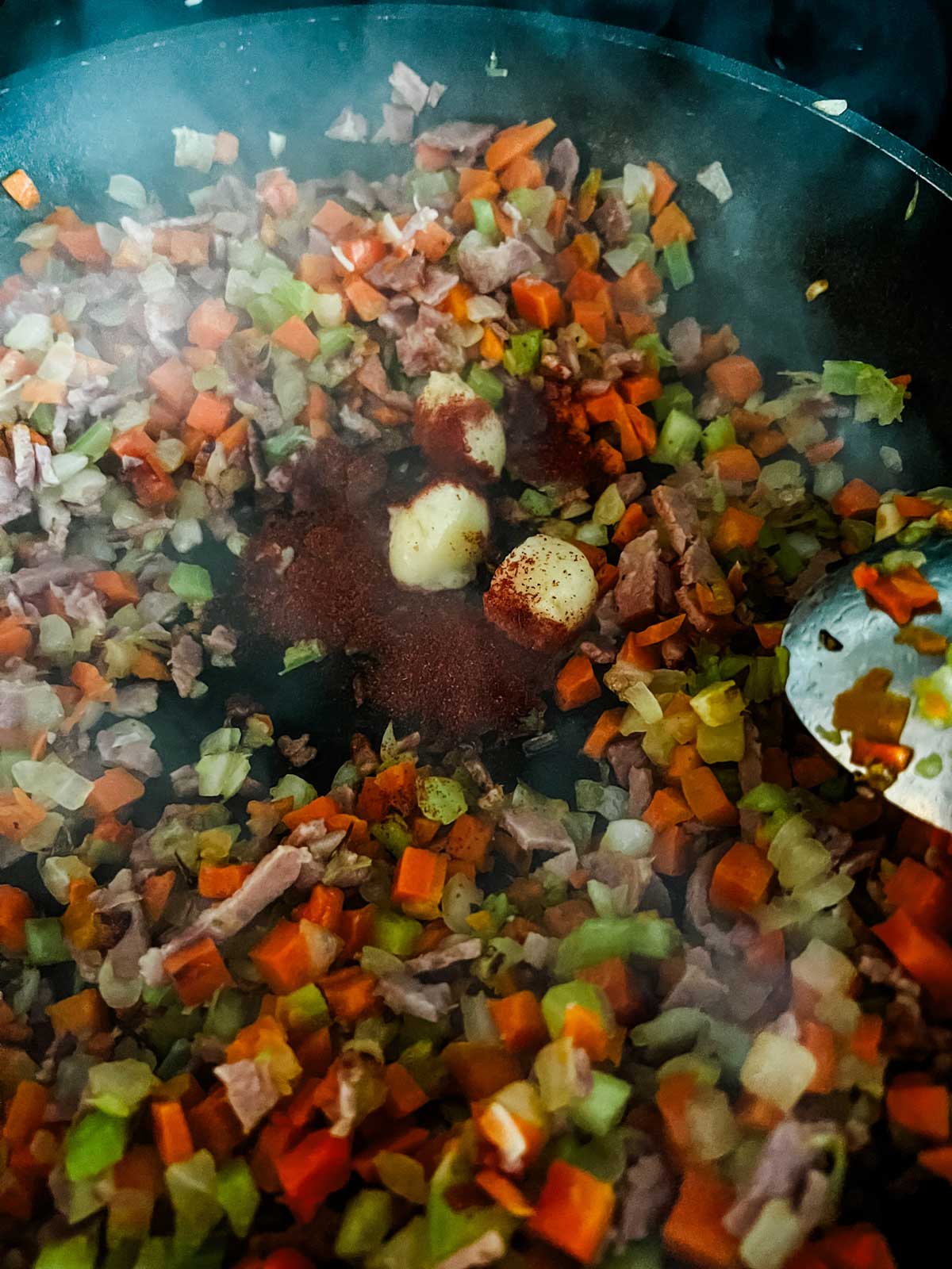 Onion, garlic, carrot, celery, and seasonings in a skillet.
