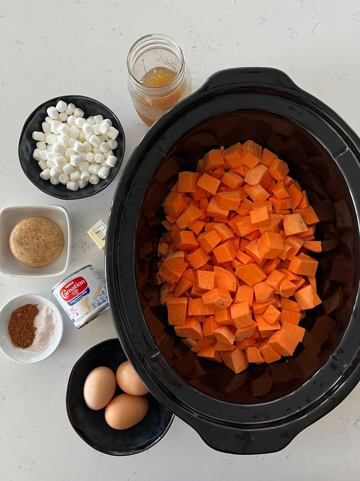 Photo of chopped sweet potatoes in a slow cooker.