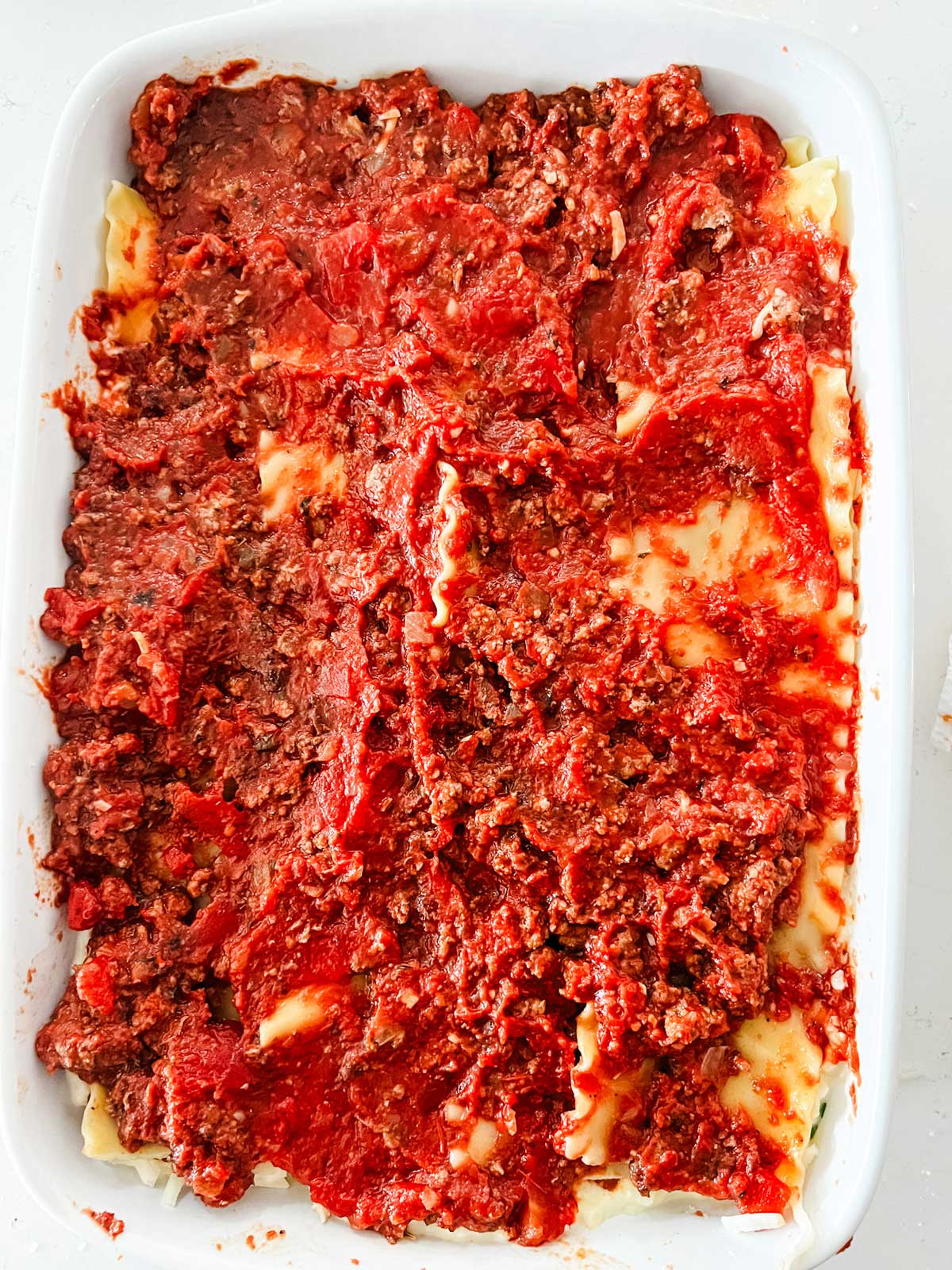 Meat sauce covering a lasagna.
