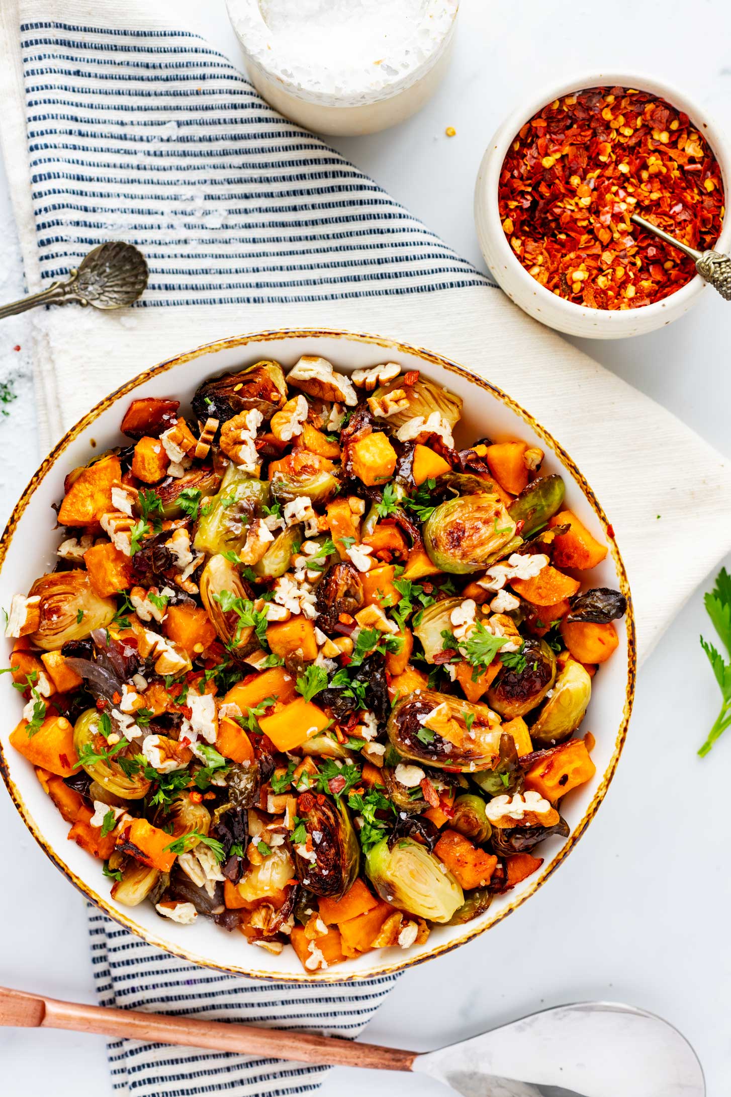 Overhead photo of a rustic bowl with roasted brussels sprouts and sweet potatoes.