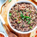 Square photo of instant pot wild rice in a bowl on a wooden platter.