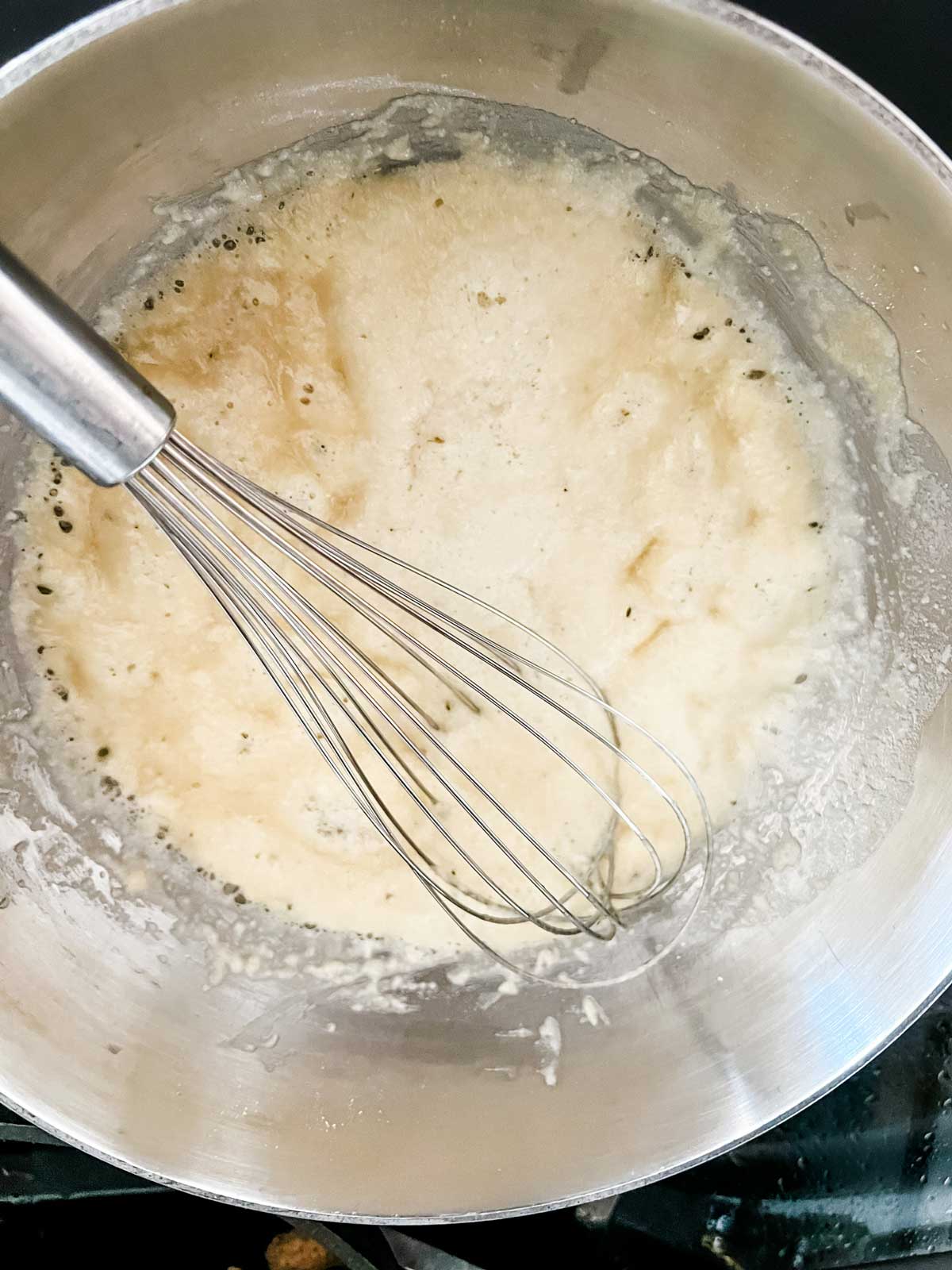 A roux forming in a saucepan.