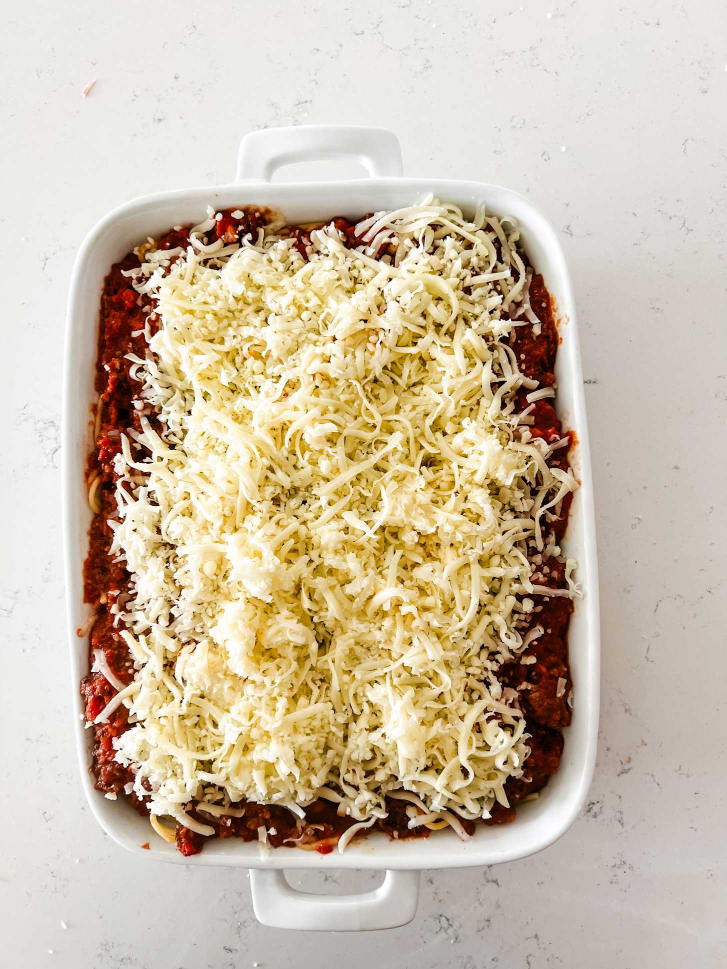 A baked spaghetti casserole ready for the oven.