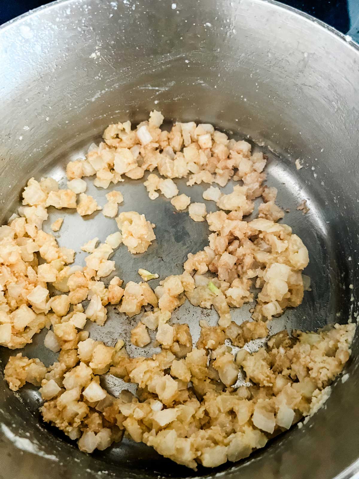 Onions sprinkled with flour in a pan.