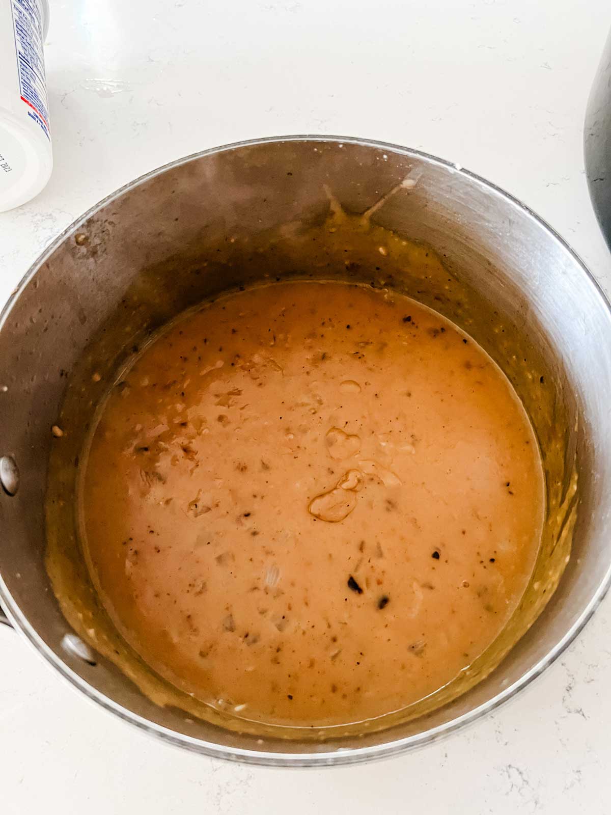 Photo of a thickened broth base sauce in a saucepan.