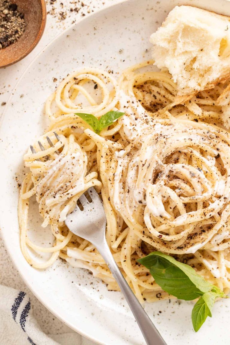 Close up photo of mascarpone pasta garnished with basil.