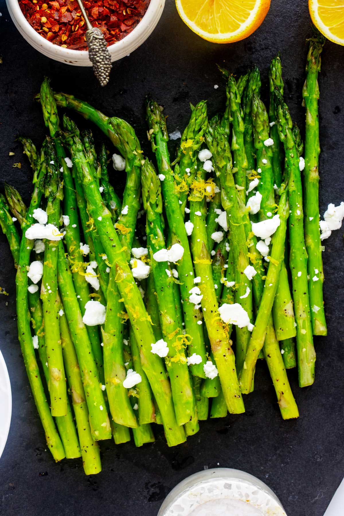 air fryer asparagus garnished with goat cheese.