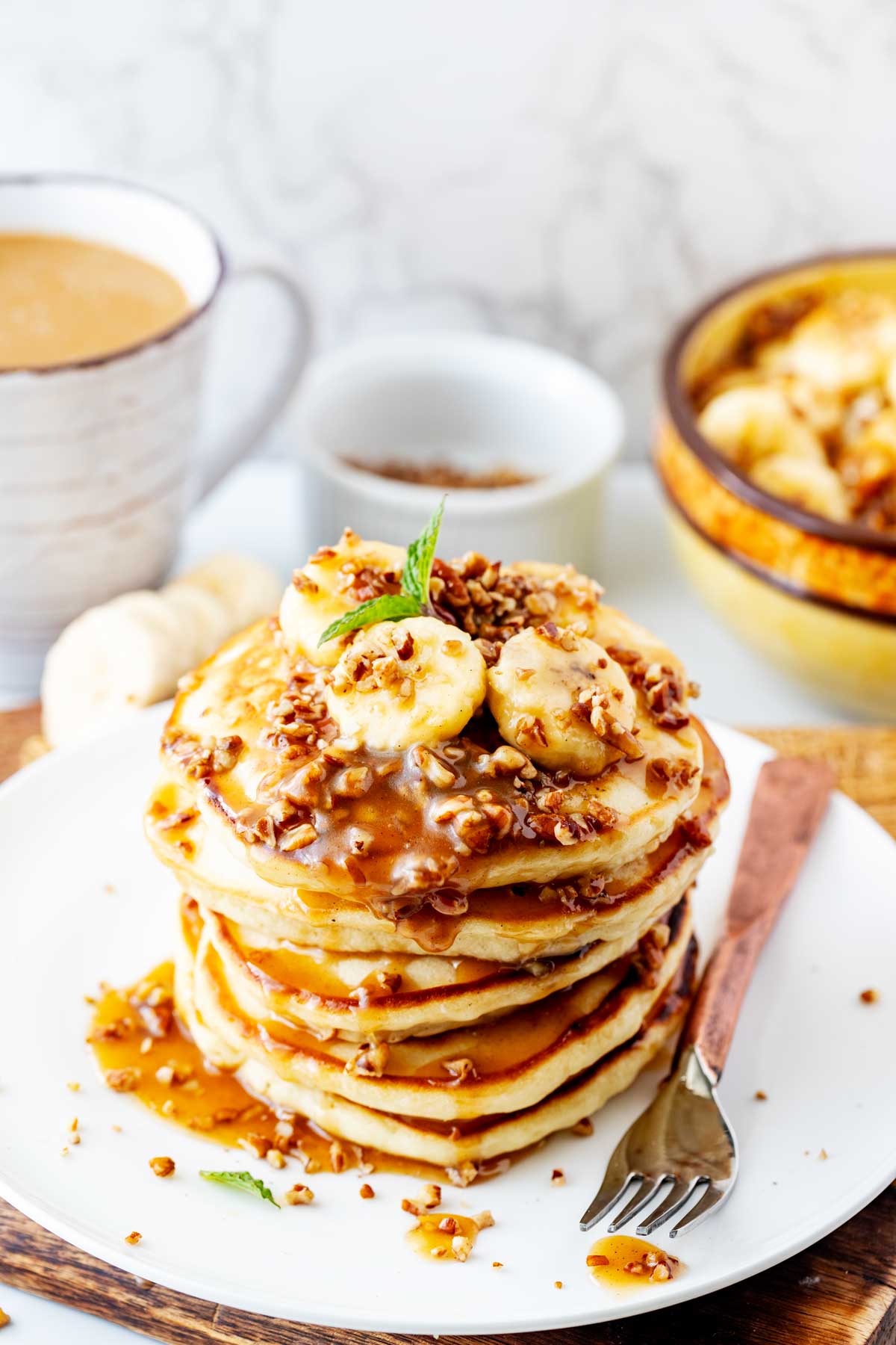 A stack of pancakes with banana sauce on top of it.