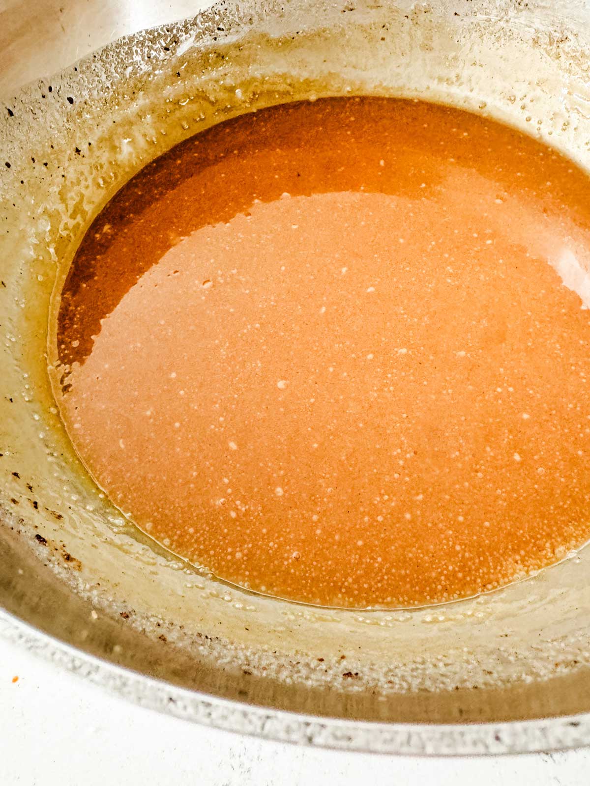 A creamy brown sugar sauce in a saucepan.