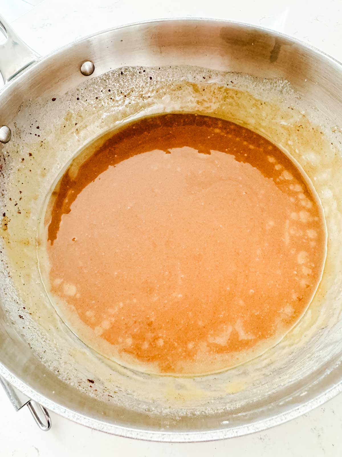 The base of banana sauce for pancakes in a sauce pan.