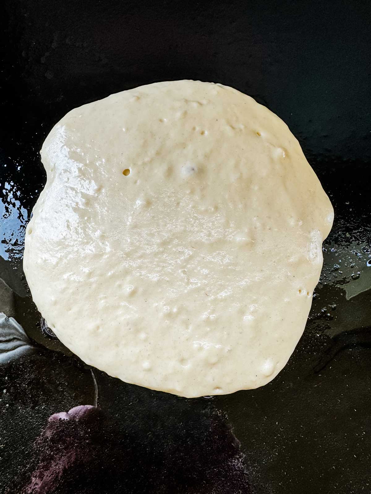 A pancake on a Blackstone Griddle that is not yet ready to flip.